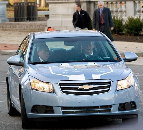 General Motors Chairman and CEO Rick Wagoner arrives for a Senate hearing driving a test version of the Chevrolet Volt extended-range electric vehicle.